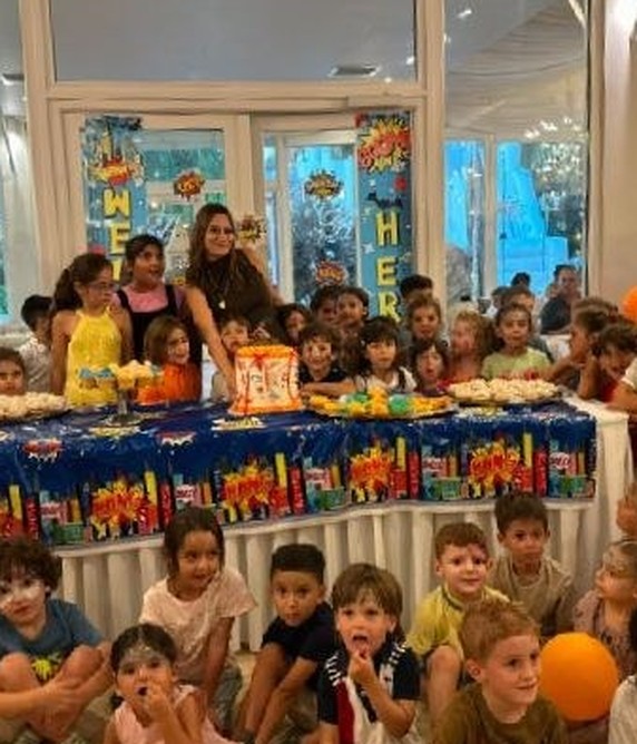 Children celebrating together at a long party table