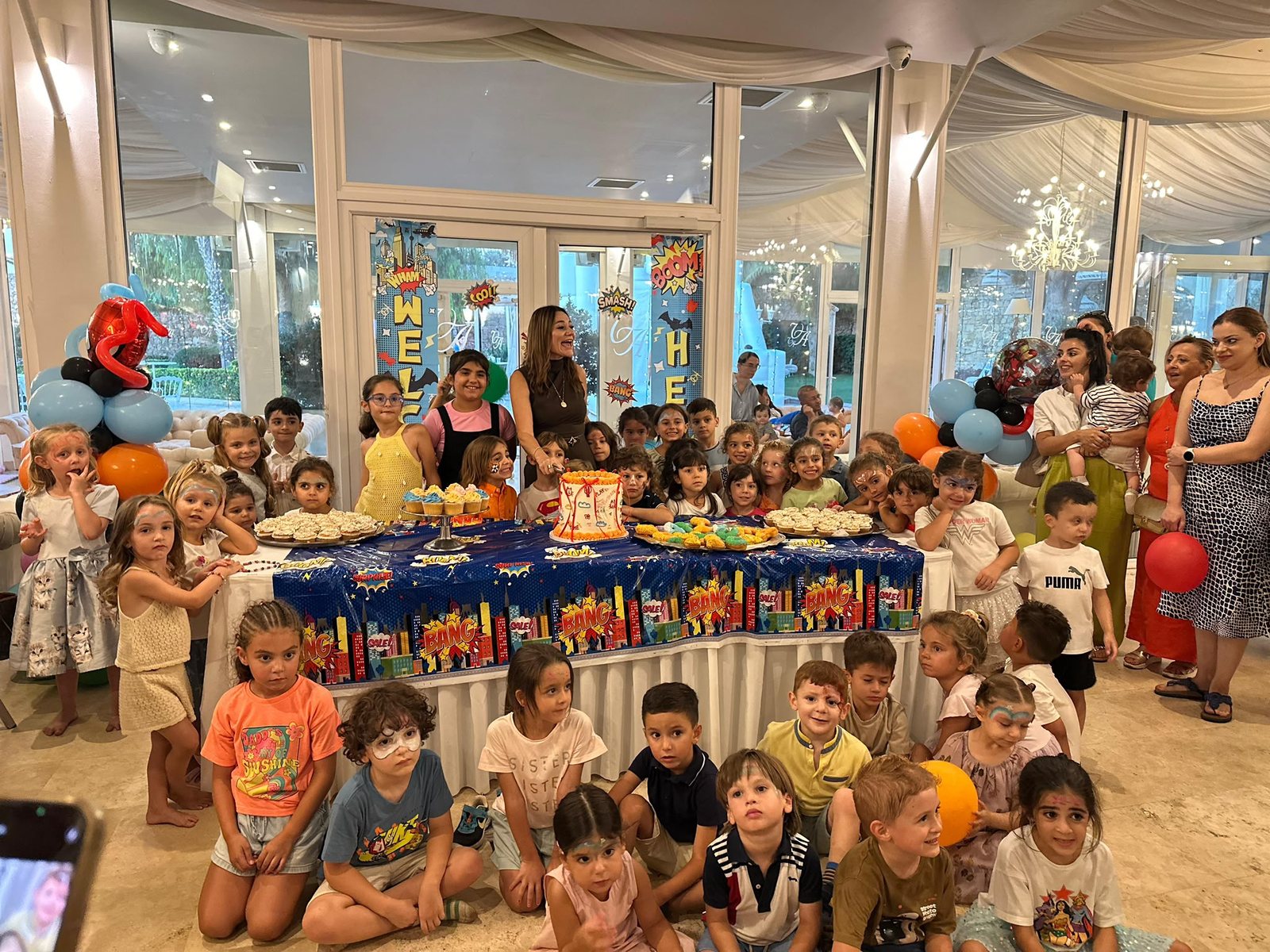 Children celebrating together at a long party table