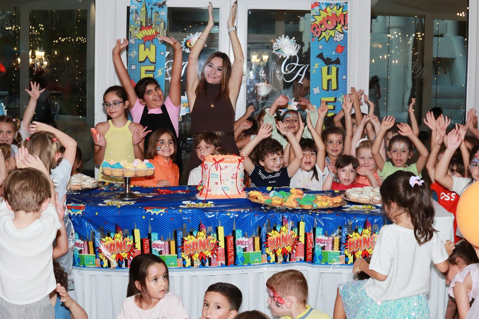 Children and staff cheering with their hands in the air