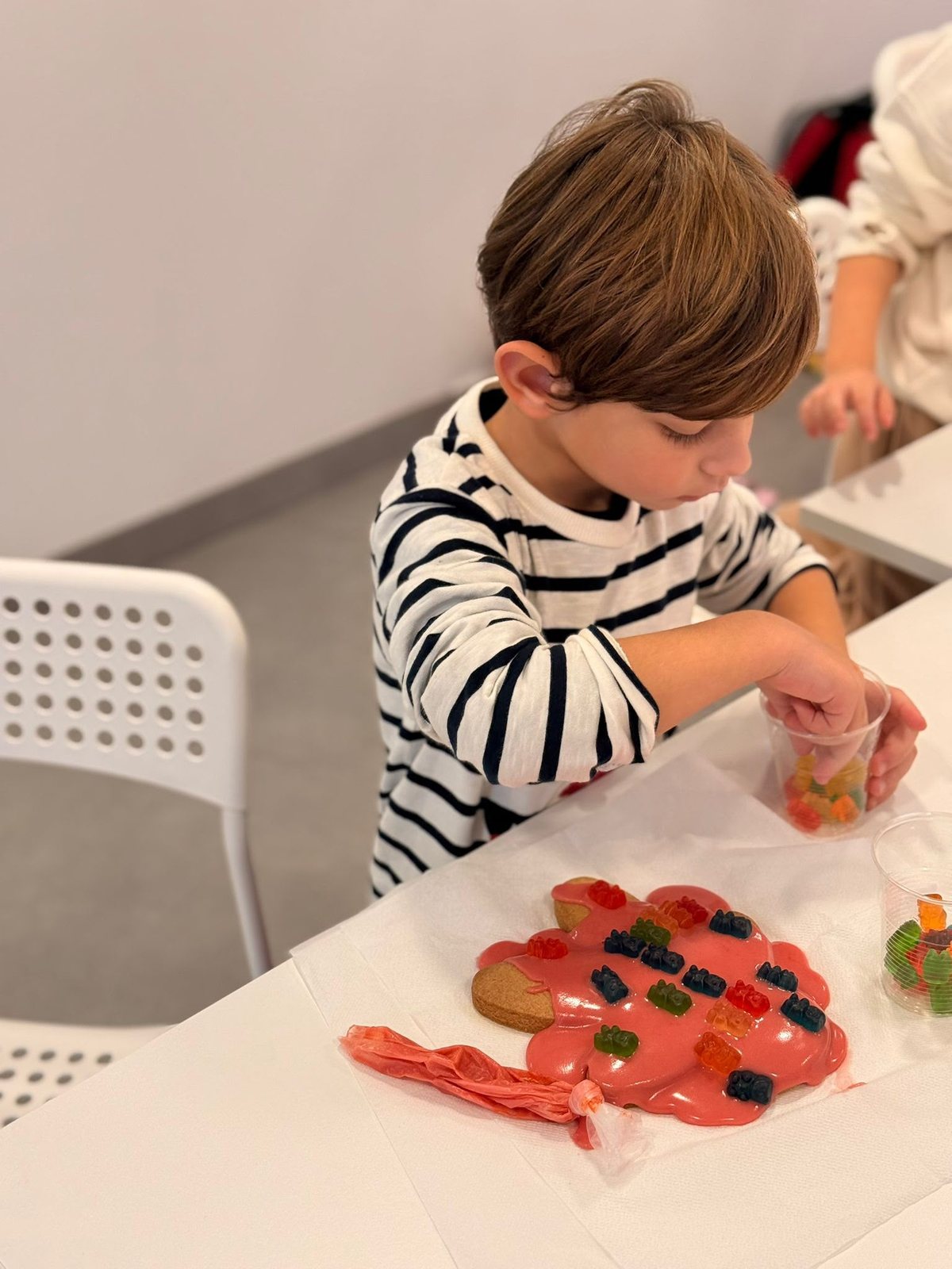 A child making a craft shape at the table