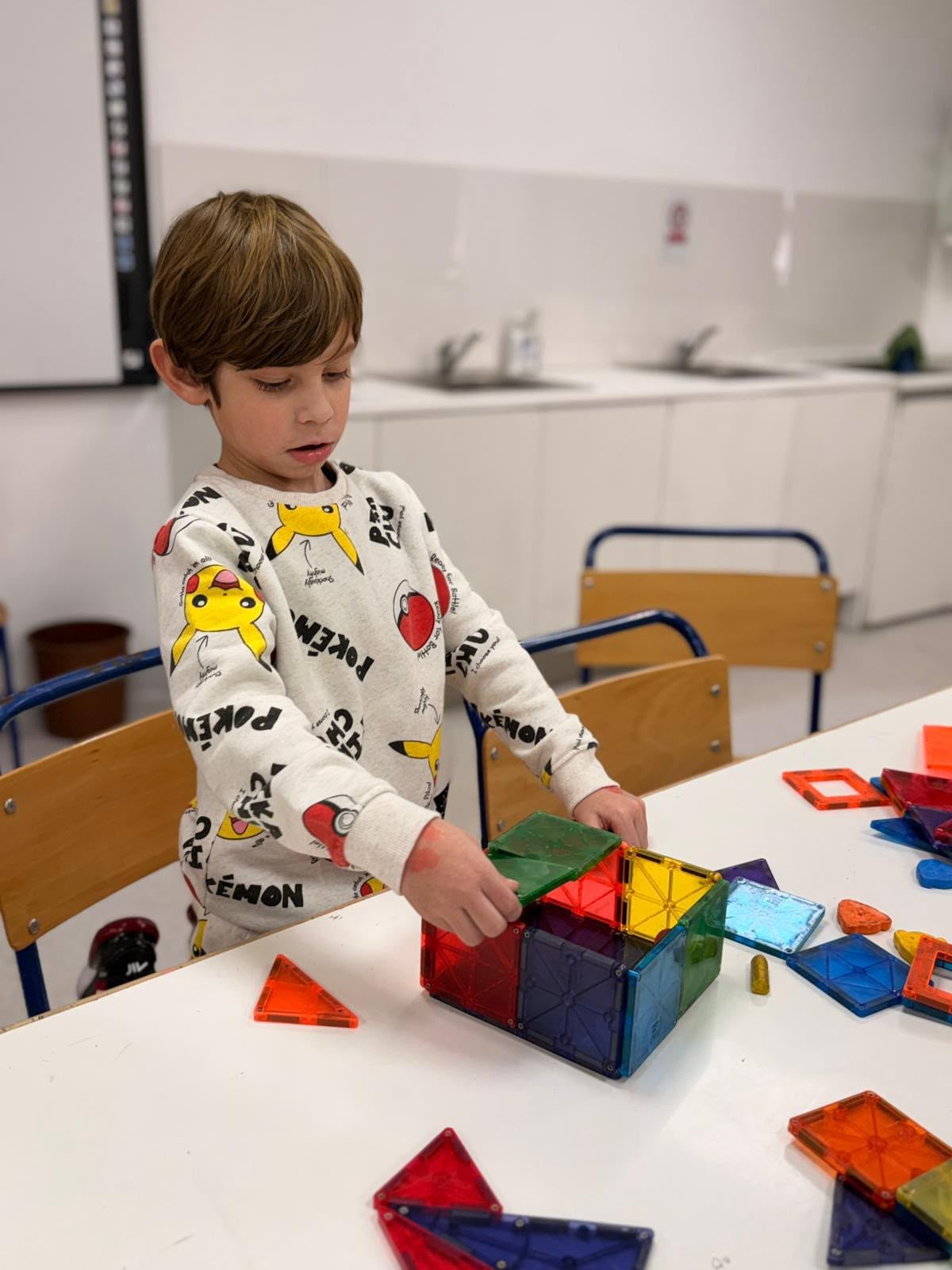 A child stacking blocks and tiles