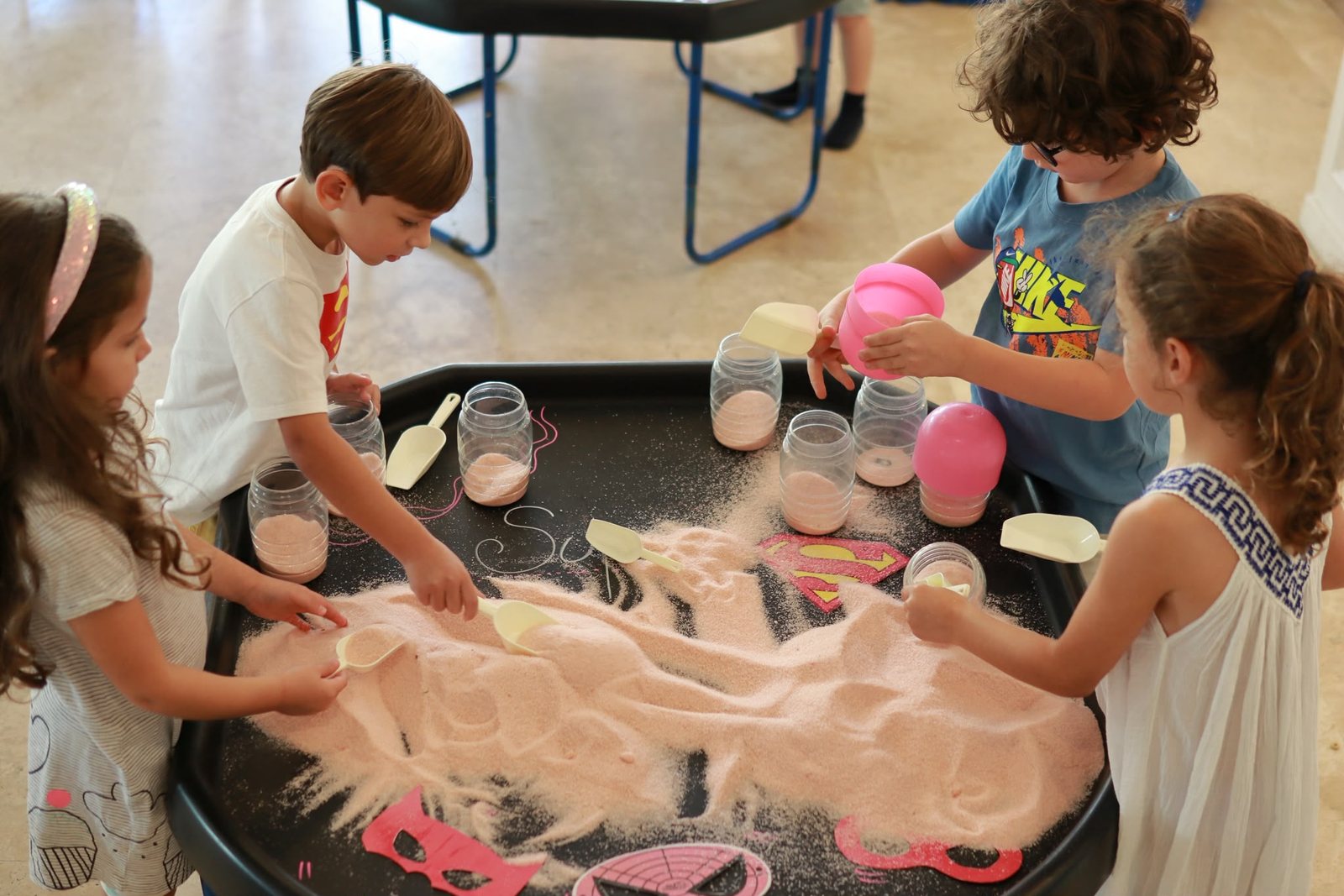Close-up of a foamy water-play table with cups