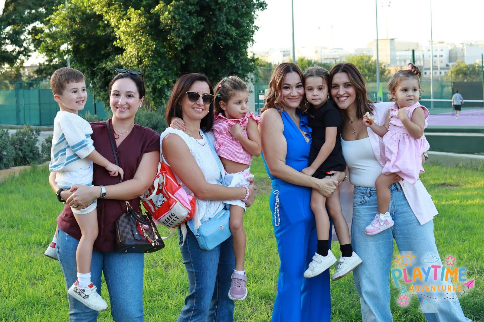 Mums and little ones smiling together at the Summer Party