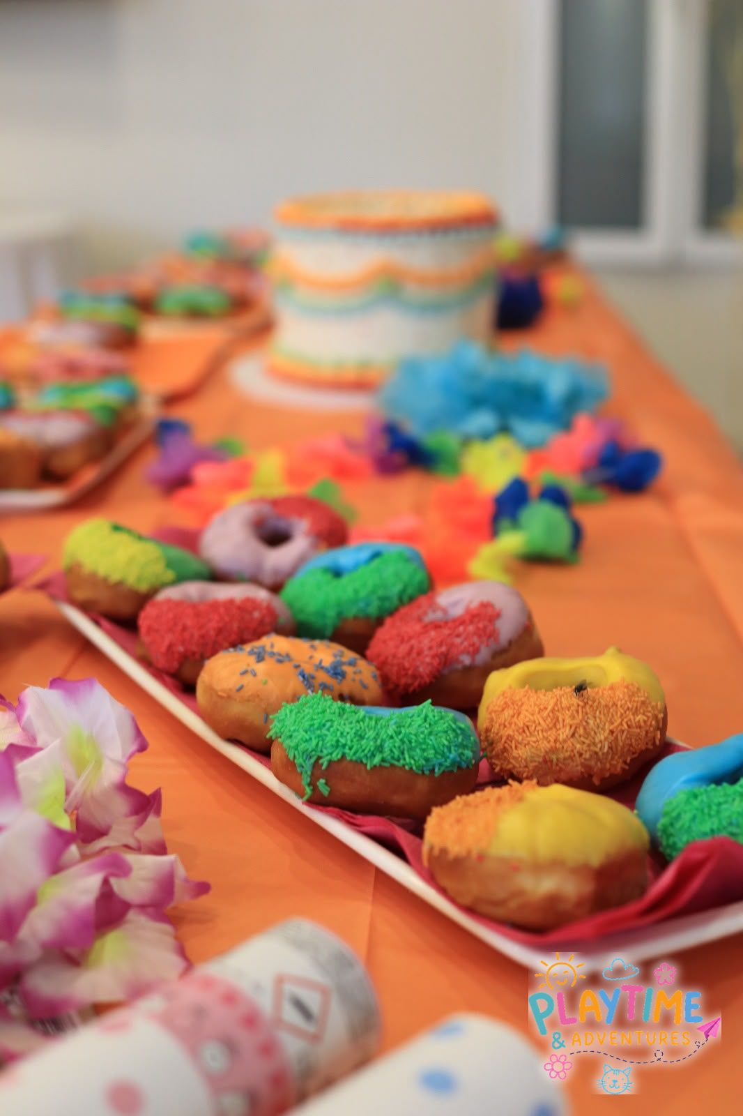 Rainbow sprinkle doughnuts on the party table