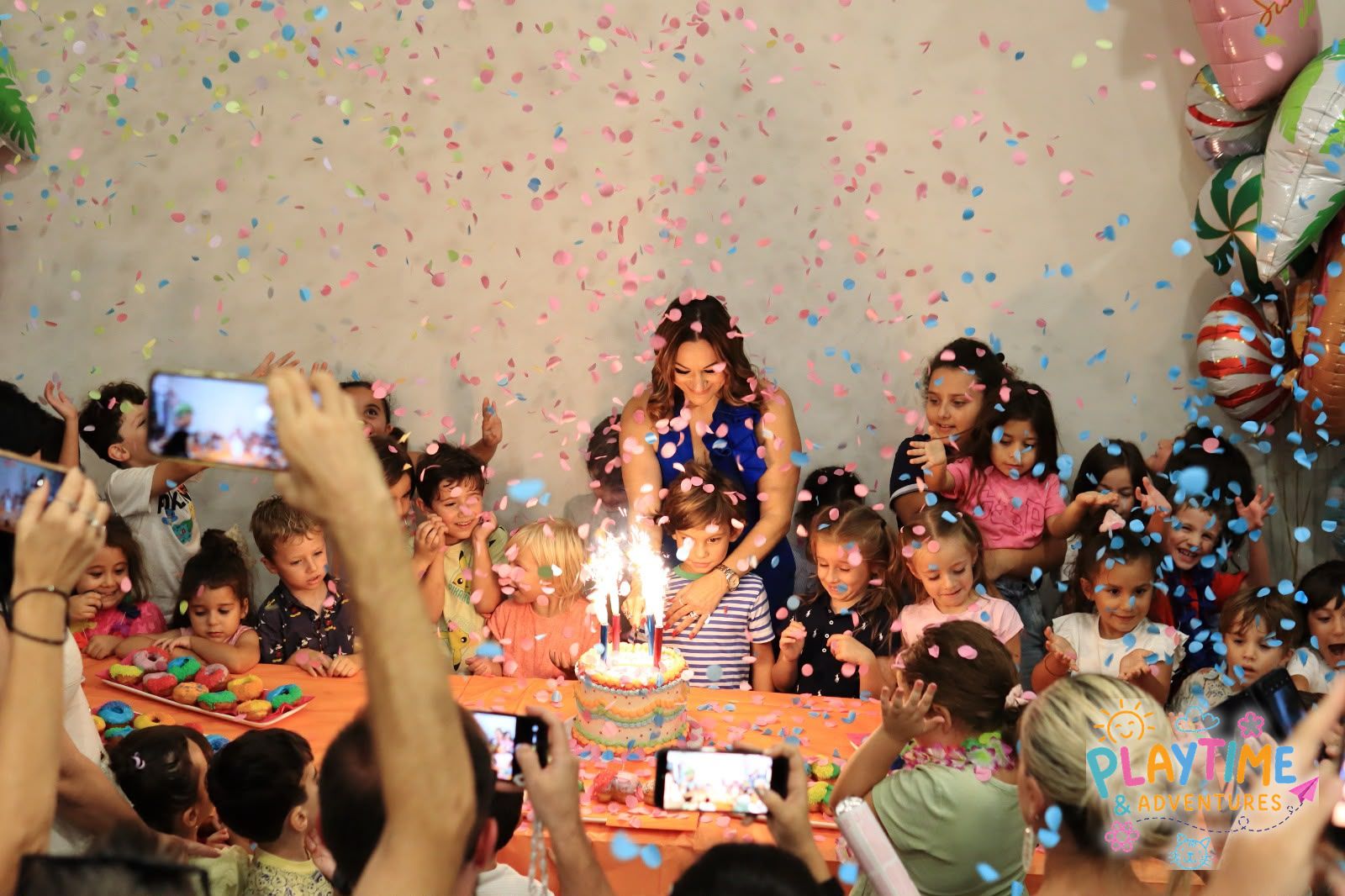 Confetti falls as the Summer Party cake is cut