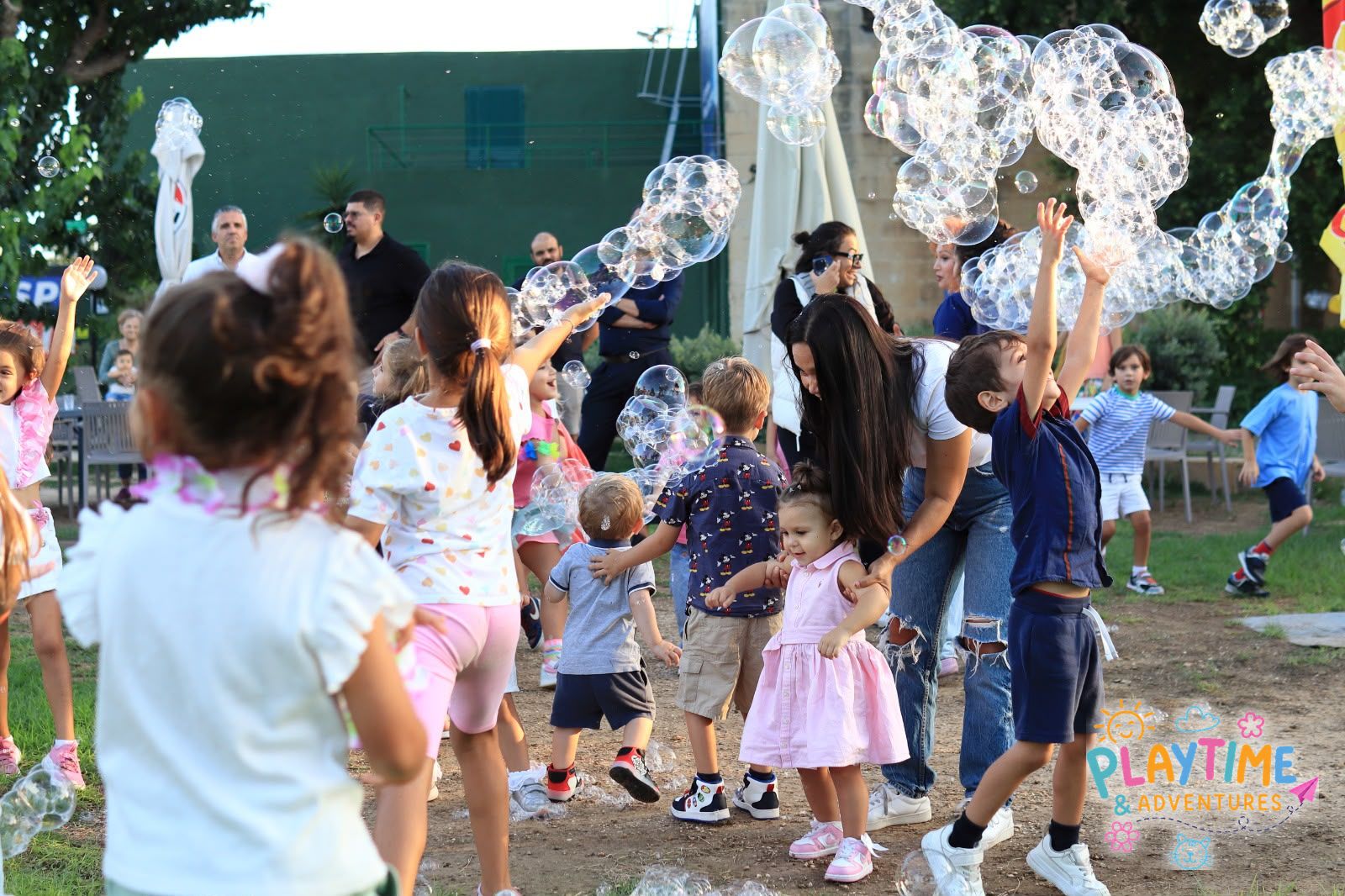 Children dancing among clouds of bubbles