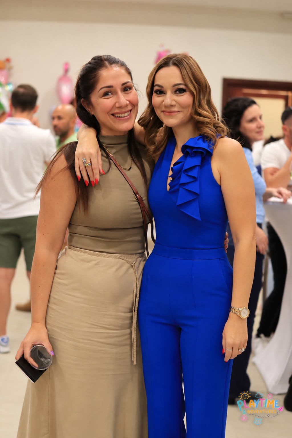 Two friends sharing a hug at the Summer Party